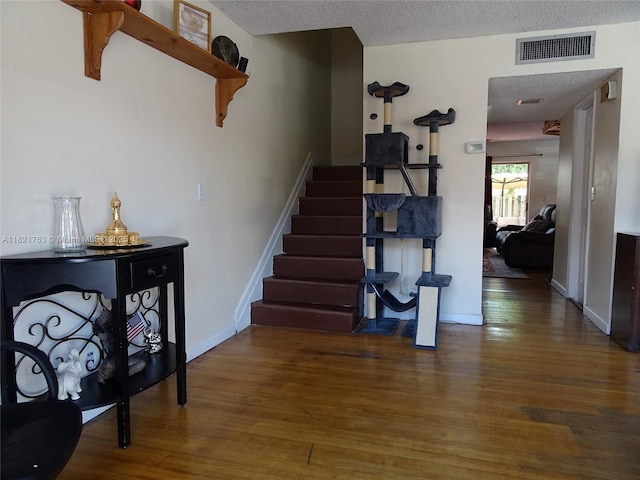6680 SW 41st Pl Unit 32, Davie, FL 33314 - staircase featuring wood finished floors and a textured ceiling