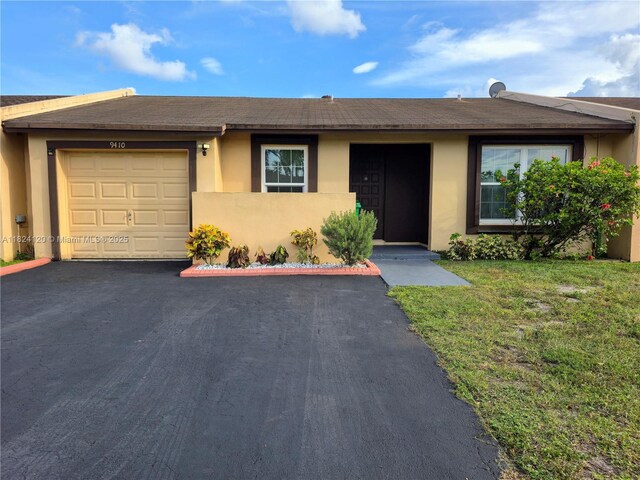 9410 S Meadows Cir, Miramar, FL 33025 - view of front of property with stucco siding, a garage, driveway, and a front lawn