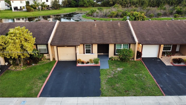 9410 S Meadows Cir, Miramar, FL 33025 - view of front facade with driveway, a garage, stucco siding, a water view, and roof with shingles