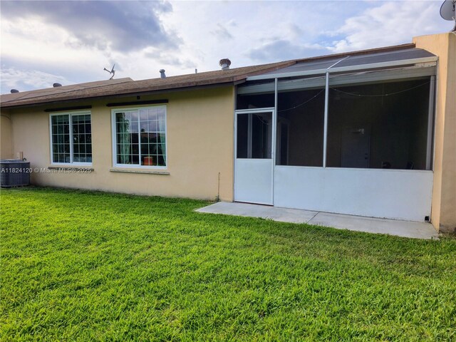 9410 S Meadows Cir, Miramar, FL 33025 - rear view of property featuring a lawn and stucco siding