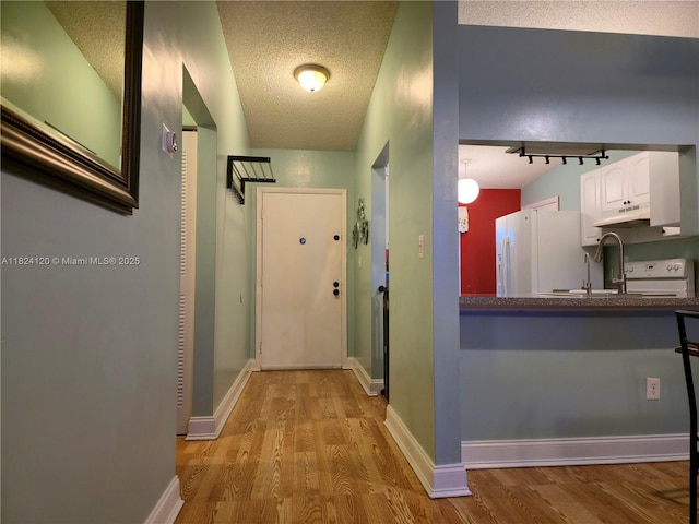 9410 S Meadows Cir, Miramar, FL 33025 - hallway featuring wood finished floors and a textured ceiling