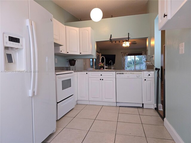 9410 S Meadows Cir, Miramar, FL 33025 - kitchen featuring white appliances, white cabinetry, light tile patterned floors, and under cabinet range hood