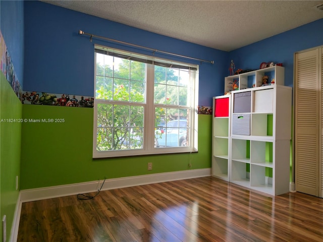 9410 S Meadows Cir, Miramar, FL 33025 - unfurnished bedroom featuring wood finished floors, multiple windows, and a textured ceiling