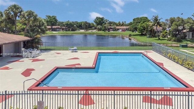 9410 S Meadows Cir, Miramar, FL 33025 - community pool with a water view and a patio