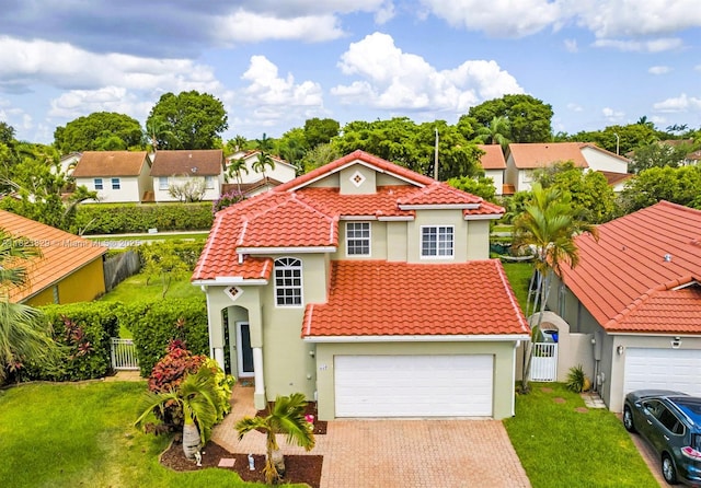 550 NW 107th Ave, Pembroke Pines, FL 33026 - mediterranean / spanish-style house with a tiled roof, a gate, stucco siding, and decorative driveway