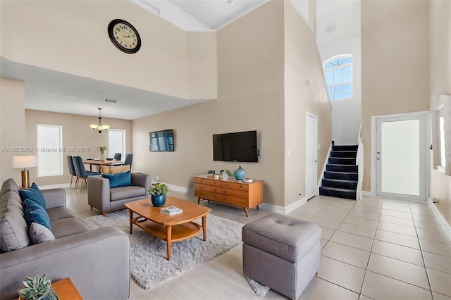 550 NW 107th Ave, Pembroke Pines, FL 33026 - living room with a high ceiling, a chandelier, light tile patterned floors, and stairs