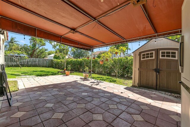 550 NW 107th Ave, Pembroke Pines, FL 33026 - fenced backyard featuring a patio area and a storage shed
