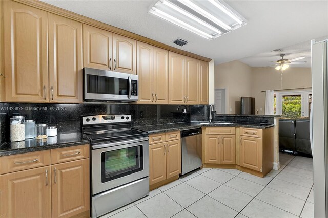 550 NW 107th Ave, Pembroke Pines, FL 33026 - kitchen with appliances with stainless steel finishes, light brown cabinetry, and decorative backsplash