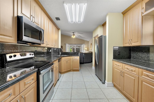 550 NW 107th Ave, Pembroke Pines, FL 33026 - kitchen featuring appliances with stainless steel finishes, light brown cabinetry, decorative backsplash, light tile patterned floors, and a ceiling fan