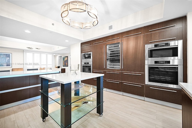 2711 S Ocean Dr Unit 3003, Hollywood, FL 33019 - kitchen featuring beverage cooler, stainless steel appliances, a chandelier, light countertops, and light wood-style floors