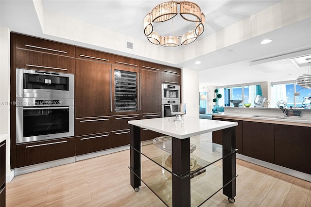 2711 S Ocean Dr Unit 3003, Hollywood, FL 33019 - kitchen with a chandelier, light countertops, beverage cooler, modern cabinets, and recessed lighting