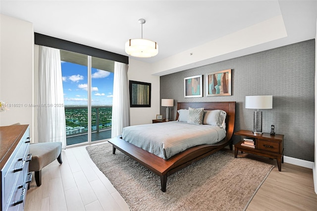 2711 S Ocean Dr Unit 3003, Hollywood, FL 33019 - bedroom with access to outside, an accent wall, light wood-style floors, and wallpapered walls