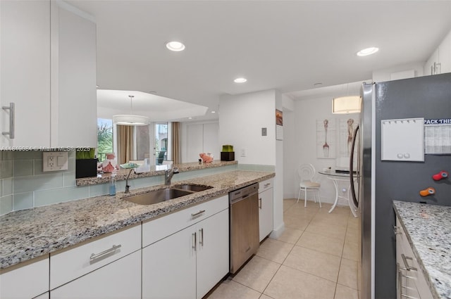 140 SE 5th Ave Unit 438, Boca Raton, FL 33432 - kitchen with stainless steel appliances, white cabinets, light tile patterned flooring, light stone countertops, and recessed lighting