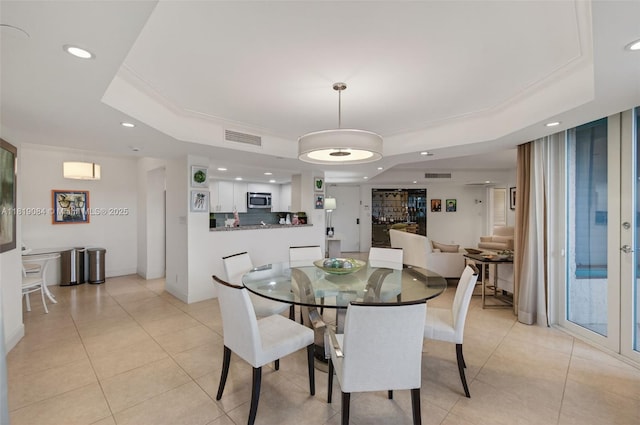 140 SE 5th Ave Unit 438, Boca Raton, FL 33432 - dining area featuring a raised ceiling, recessed lighting, light tile patterned floors, and ornamental molding