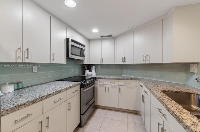 140 SE 5th Ave Unit 438, Boca Raton, FL 33432 - kitchen with appliances with stainless steel finishes, decorative backsplash, white cabinets, and recessed lighting