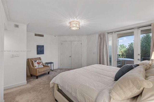 140 SE 5th Ave Unit 438, Boca Raton, FL 33432 - bedroom with light carpet, access to exterior, and ornamental molding