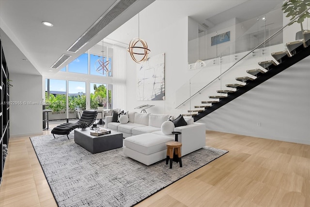 4701 N Meridian Ave Unit 217, Miami Beach, FL 33140 - living area featuring stairs, a towering ceiling, recessed lighting, and floor to ceiling windows