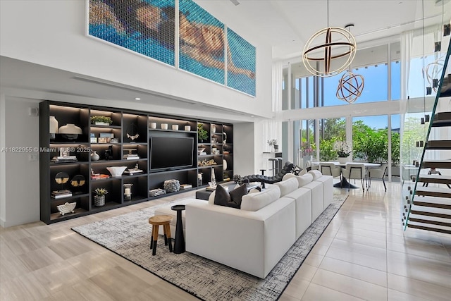 4701 N Meridian Ave Unit 217, Miami Beach, FL 33140 - living room with a high ceiling, tile patterned floors, and a chandelier