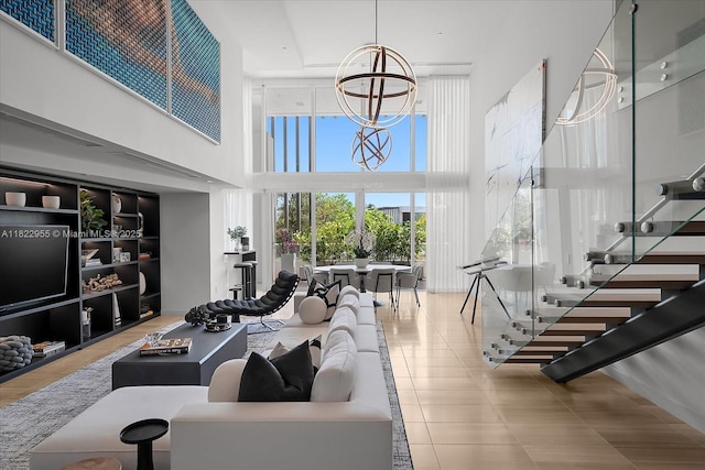 4701 N Meridian Ave Unit 217, Miami Beach, FL 33140 - tiled living room featuring a towering ceiling and a chandelier