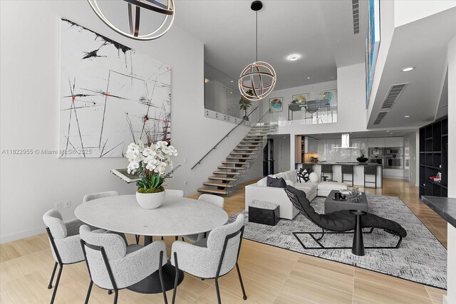 4701 N Meridian Ave Unit 217, Miami Beach, FL 33140 - dining space with stairs, a chandelier, recessed lighting, and wood finished floors
