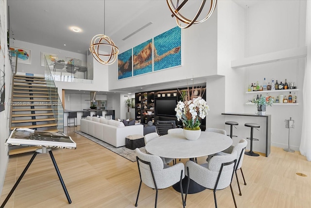 4701 N Meridian Ave Unit 217, Miami Beach, FL 33140 - dining area with a high ceiling, stairway, and wood finished floors