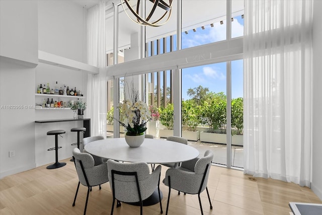 4701 N Meridian Ave Unit 217, Miami Beach, FL 33140 - dining room featuring a towering ceiling and a dry bar