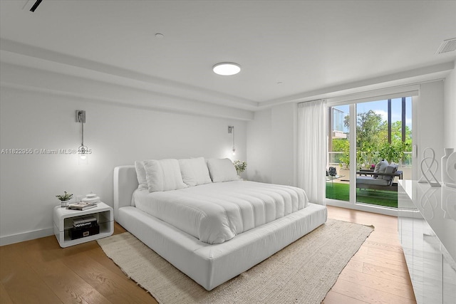 4701 N Meridian Ave Unit 217, Miami Beach, FL 33140 - bedroom featuring access to exterior and wood finished floors