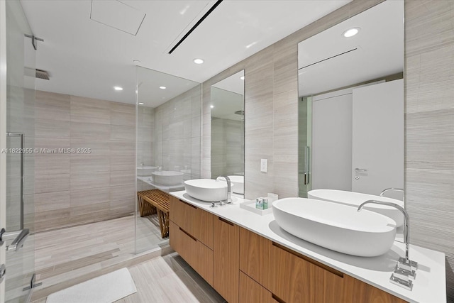 4701 N Meridian Ave Unit 217, Miami Beach, FL 33140 - full bathroom featuring tile walls, a tile shower, double vanity, and recessed lighting