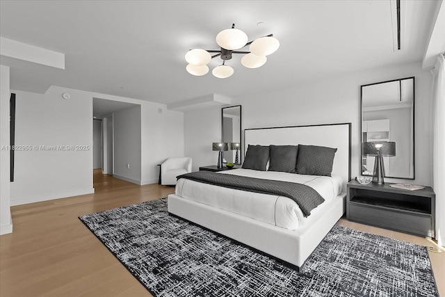 4701 N Meridian Ave Unit 217, Miami Beach, FL 33140 - bedroom with wood finished floors and a chandelier