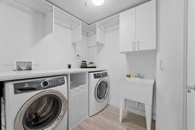 4701 N Meridian Ave Unit 217, Miami Beach, FL 33140 - laundry room featuring cabinet space, independent washer and dryer, and light wood finished floors