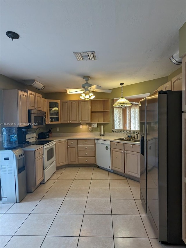 585 SE 25th Ln, Homestead, FL 33033 - kitchen featuring stainless steel appliances, light tile patterned floors, light countertops, pendant lighting, and open shelves