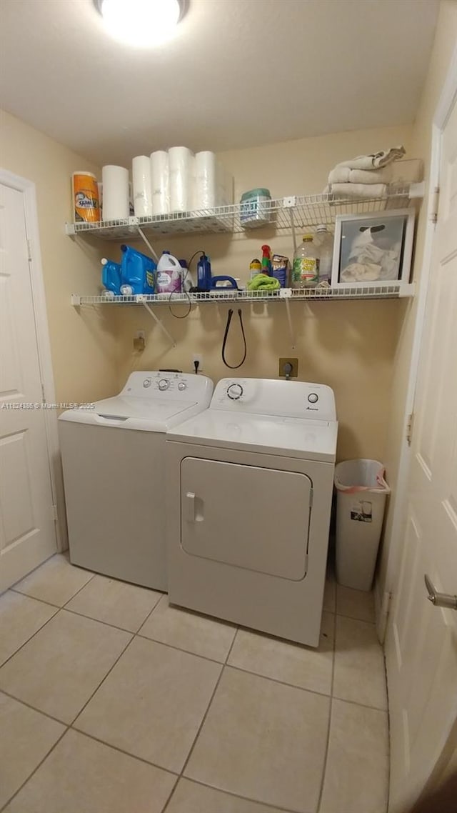 585 SE 25th Ln, Homestead, FL 33033 - laundry area with independent washer and dryer and light tile patterned flooring