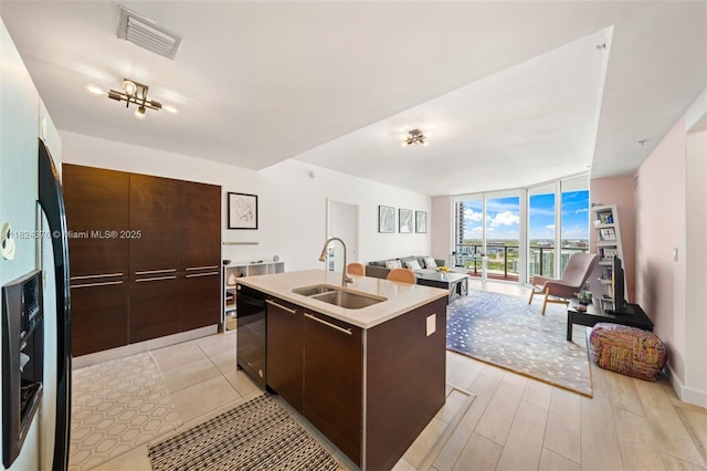 1900 N Bayshore Dr Unit 2514, Miami, FL 33132 - kitchen featuring modern cabinets, a wall of windows, open floor plan, dark brown cabinets, and dishwasher