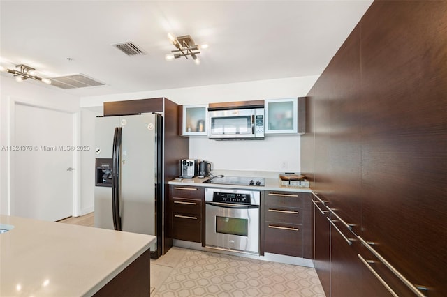 1900 N Bayshore Dr Unit 2514, Miami, FL 33132 - kitchen with appliances with stainless steel finishes, dark brown cabinetry, glass insert cabinets, and light countertops