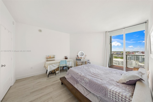 1900 N Bayshore Dr Unit 2514, Miami, FL 33132 - bedroom with light wood-style flooring, access to exterior, and floor to ceiling windows