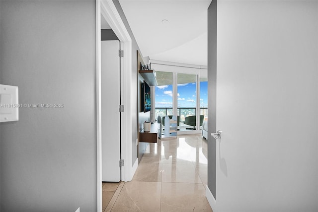 17121 Collins Ave Unit 2304, Sunny Isles Beach, FL 33160 - corridor with baseboards and floor to ceiling windows