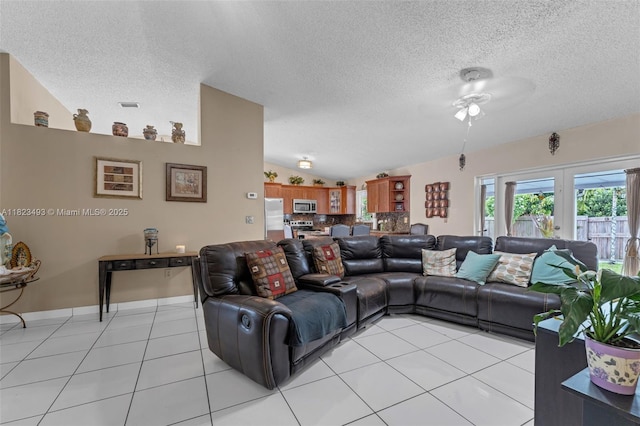 14548 SW 98th Ter, Miami, FL 33186 - living area featuring a ceiling fan, a textured ceiling, light tile patterned floors, and vaulted ceiling