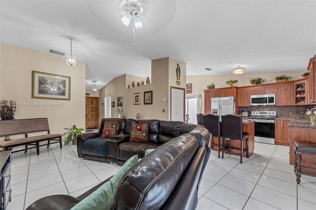 14548 SW 98th Ter, Miami, FL 33186 - living room featuring a ceiling fan, light tile patterned flooring, and a textured ceiling