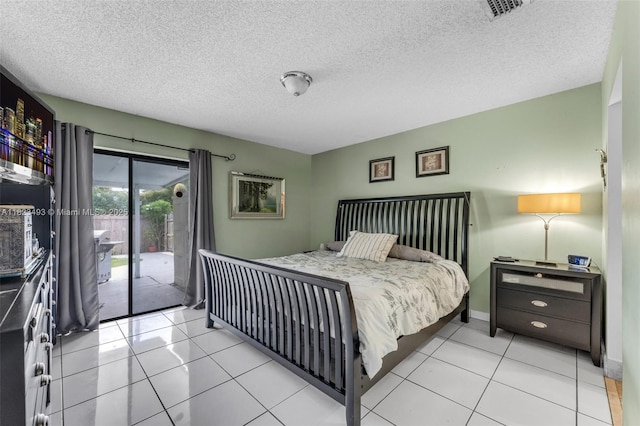 14548 SW 98th Ter, Miami, FL 33186 - bedroom with access to exterior, a textured ceiling, and light tile patterned floors