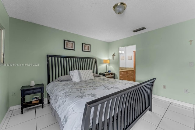 14548 SW 98th Ter, Miami, FL 33186 - bedroom featuring light tile patterned floors and a textured ceiling