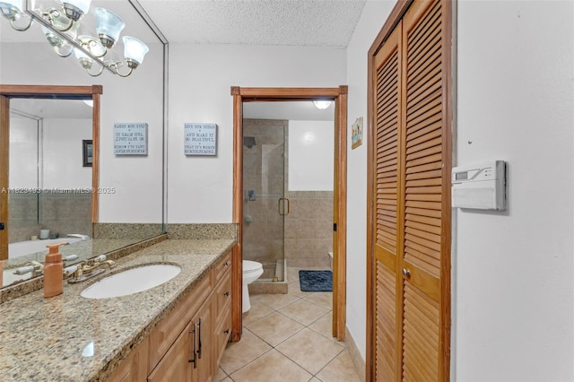 14548 SW 98th Ter, Miami, FL 33186 - bathroom featuring a closet, tile patterned flooring, vanity, a shower stall, and a textured ceiling