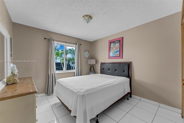 14548 SW 98th Ter, Miami, FL 33186 - bedroom featuring a textured ceiling and light tile patterned floors