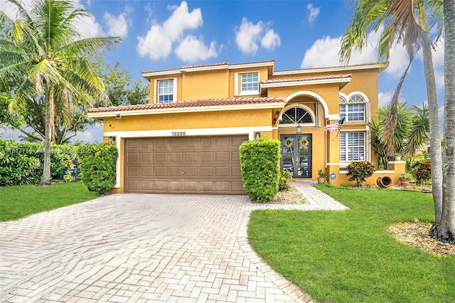 13290 SW 54th Ct, Miramar, FL 33027 - mediterranean / spanish house featuring stucco siding, french doors, decorative driveway, and a front yard