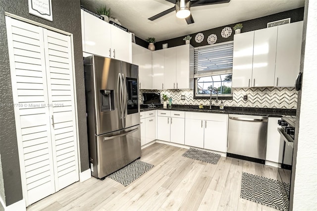 13290 SW 54th Ct, Miramar, FL 33027 - kitchen with appliances with stainless steel finishes, light wood-type flooring, ceiling fan, backsplash, and a textured wall