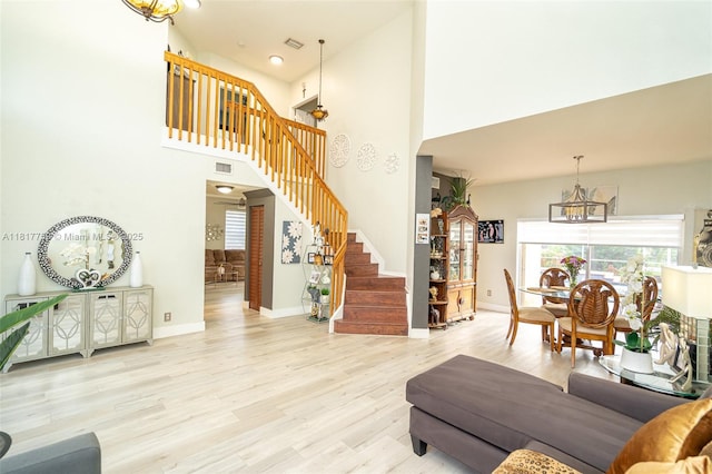 13290 SW 54th Ct, Miramar, FL 33027 - living area featuring a chandelier, stairway, a towering ceiling, and wood finished floors