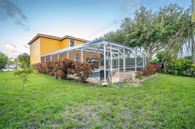 13290 SW 54th Ct, Miramar, FL 33027 - back of house with a lawn, an outdoor pool, stucco siding, and a patio area