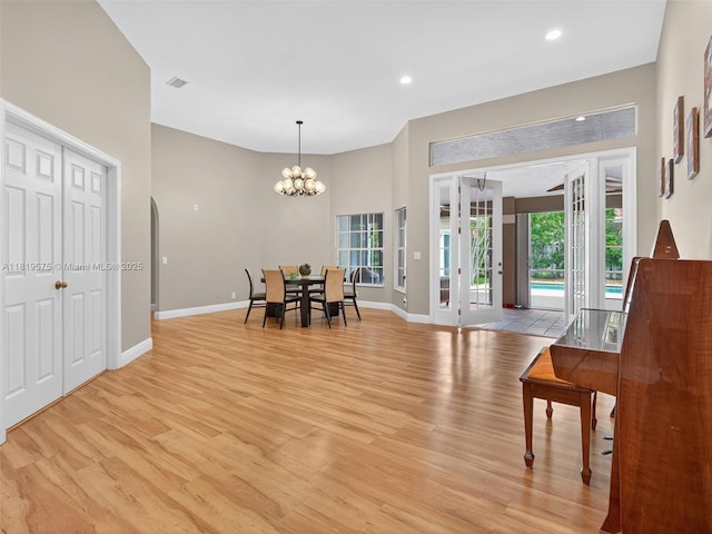 782 Lake Blvd, Weston, FL 33326 - dining space featuring light wood-type flooring, plenty of natural light, a chandelier, recessed lighting, and arched walkways