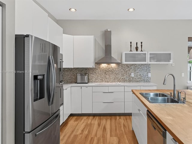 782 Lake Blvd, Weston, FL 33326 - kitchen featuring stainless steel appliances, wall chimney exhaust hood, white cabinets, light wood-style flooring, and recessed lighting