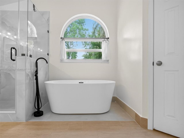 782 Lake Blvd, Weston, FL 33326 - bathroom featuring a freestanding bath and a stall shower