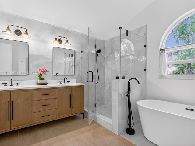 782 Lake Blvd, Weston, FL 33326 - full bathroom with a stall shower, a soaking tub, double vanity, lofted ceiling, and wood finished floors